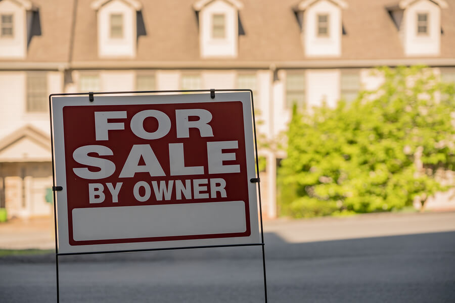 Blank For Sale By Owner Sign In Front Of A Row Of Town Houses Or